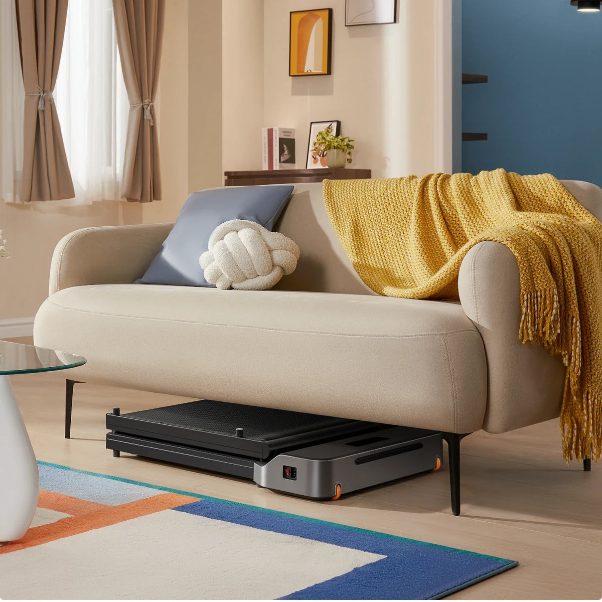 WalkingPad Z1 treadmill stored under a sofa